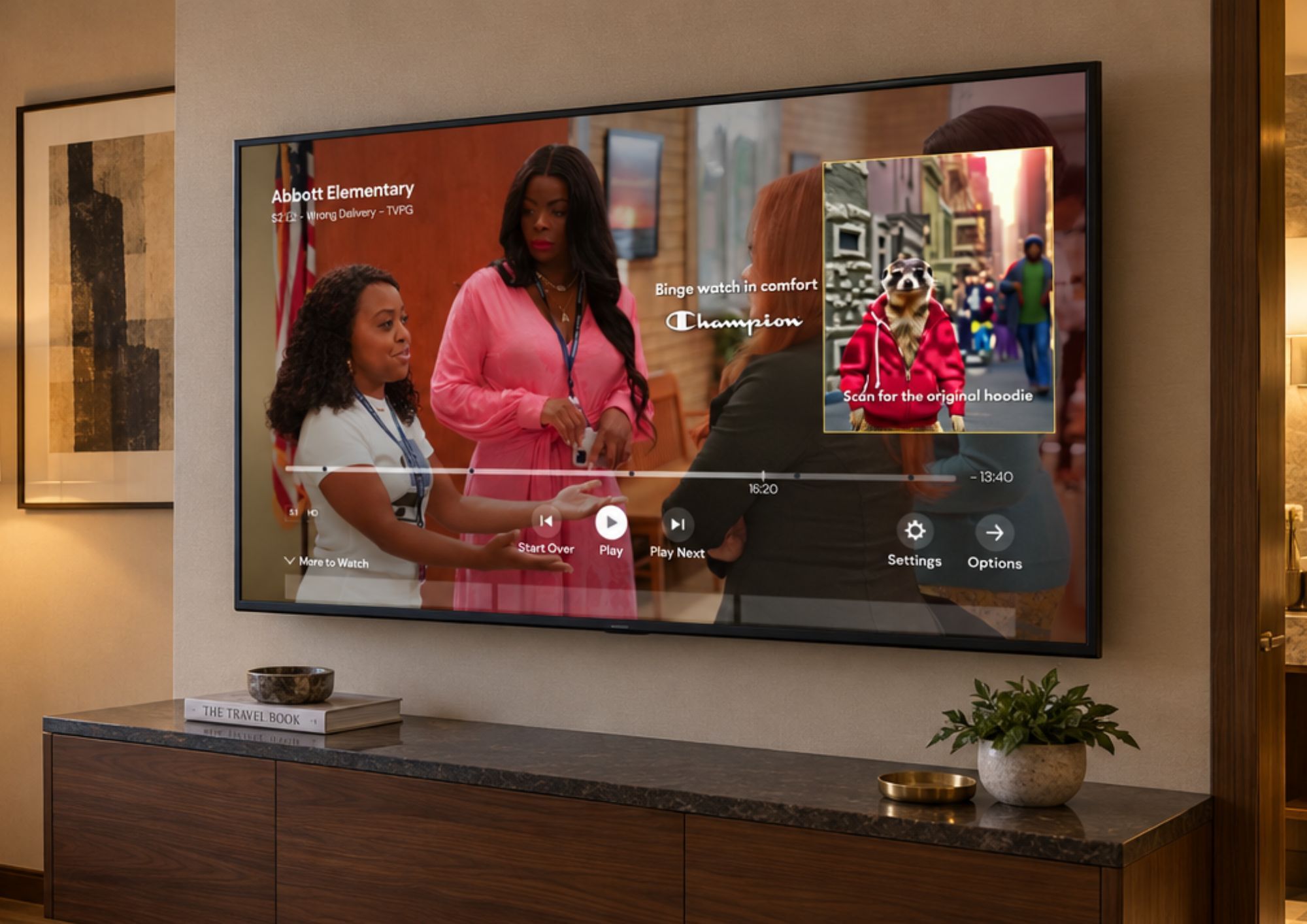 A streaming app genuinely paused mid-episode, with a Champion clothing Pause Ad overlay reading “Binge watch in comfort” and a meerkat wearing a red hoodie as the scannable StoryCode, captioned “Scan for the original hoodie.”